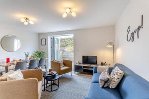 a living room with a blue couch and a dining room at 3 Bed in Middlesmoor oc-w30366 in Middlesmoor