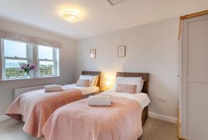 a bedroom with two beds and a window at 3 Bed in Middlesmoor oc-w30366 in Middlesmoor