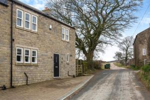 an empty dirt road next to a brick building at 3 Bed in Middlesmoor oc-w30366 in Middlesmoor