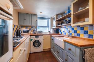 a kitchen with a washing machine and a washer at 2 Bed in Castleton oc-o30120 in Castleton +7 photos