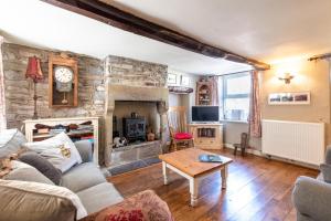a living room with a stone wall at 2 Bed in Castleton oc-o30120 in Castleton