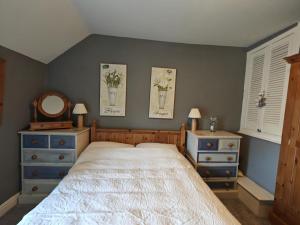 a bedroom with a bed and two dressers and a mirror at 2 Bed in Castleton oc-o30120 in Castleton