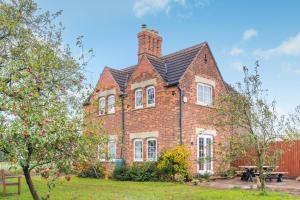 a brick house with a chimney on top of it at 3 Bed in Fulbeck oc-v33643 in Fulbeck
