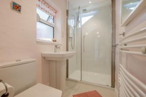 a white bathroom with a shower and a sink at 4 Bed in Tintagel oc-trev in Treknow +50 photos