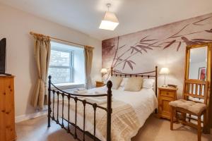 a bedroom with a large bed and a window at 5 Bed in Kettlewell oc-ds257 in Kettlewell