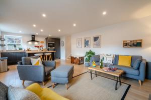 a living room with blue and yellow furniture and a kitchen at 2 Bed in Dunkeld oc-i30992 in Dunkeld