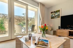 a living room with a table and a large window at 2 Bed in Beadnell oc-s30910 in Beadnell