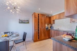 a kitchen with wooden cabinets and a counter top at 2 Bed in Beadnell oc-s30910 in Beadnell