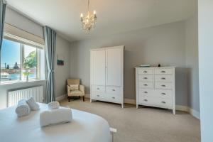 a bedroom with a bed and a dresser and a window at 2 Bed in Beadnell oc-s30910 in Beadnell