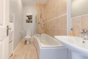 a bathroom with a tub and a sink and a toilet at 2 Bed in Beadnell oc-s30910 in Beadnell +17 photos