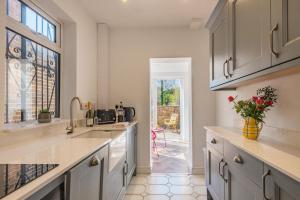 a kitchen with white cabinets and a large window at 2 Bed in Lowestoft oc-c31866 in Lowestoft
