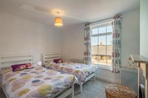a bedroom with two beds and a window at 2 Bed in Lowestoft oc-c31866 in Lowestoft