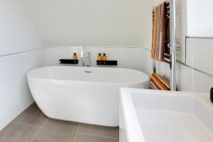 a white bath tub in a white bathroom at 1 Bed in Booton oc-2266 in Cawston