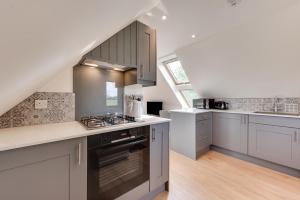 a kitchen with white cabinets and a stove top oven at 1 Bed in Booton oc-2266 in Cawston