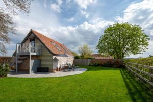 a house with a balcony and a yard at 1 Bed in Booton oc-2266 in Cawston
