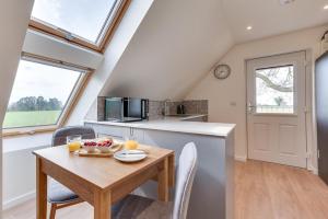 a kitchen and dining room with a table and chairs at 1 Bed in Booton oc-2266 in Cawston +5 photos
