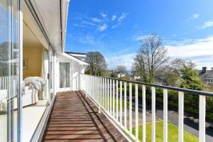 a balcony with a view of a house at 3 Bed in Llanbedrog oc-gerddi in Llanbedrog