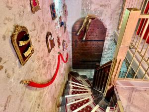a staircase in a building with a red ribbon on the wall at Caporizon - La Damoiselle in Chancelade