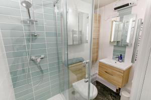 a bathroom with a shower with a toilet and a sink at 1 Bed in Fowey oc-m27634 in Fowey +8 photos
