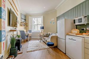 a kitchen and living room with a couch and a table at 1 Bed in Fowey oc-m27634 in Fowey