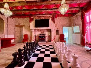 a large room with a chess board and a tv at Caporizon - La Damoiselle in Chancelade