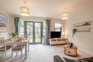 a living room with a table and a television at 2 Bed in Mundesley oc-r31875 in Mundesley