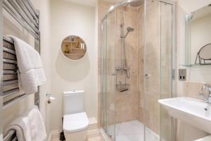 a bathroom with a shower and a toilet and a sink at 2 Bed in Mundesley oc-r31875 in Mundesley +18 photos