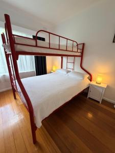 a bedroom with a double bunk bed with two lamps at Genesta House in Cowes
