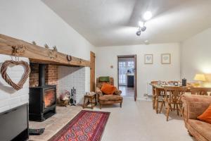 a living room with a fireplace and a table at 2 Bed in Buxton oc-b30030 in Buxton