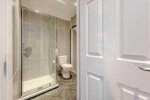 a bathroom with a toilet and a glass shower at 1 Bed in Tenby oc-w28986 in Tenby