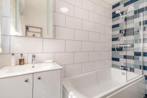 a white bathroom with a tub and a sink at 3 Bed in Ledbury oc-s32045 in Ledbury +15 photos
