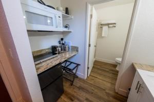 a small kitchen with a counter and a microwave at Amador Hotel in Pioneer