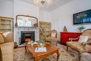a living room with a fireplace and a table and chairs at 4 Bed in Beamish oc-o32025 in Beamish