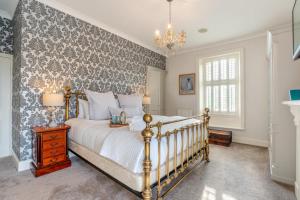 a bedroom with a bed and a wall covered in wallpaper at 4 Bed in Beamish oc-o32025 in Beamish