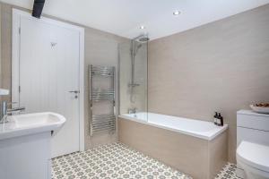 a bathroom with a tub and a toilet and a sink at 3 Bed in Reeth oc-l32438 in Reeth +19 photos