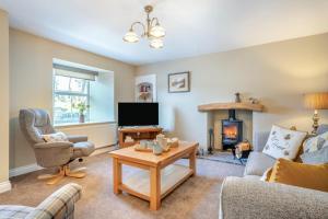 a living room with a couch and a fireplace at 3 Bed in Reeth oc-l32438 in Reeth