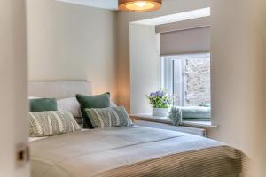 a bedroom with a bed with pillows and a window at 3 Bed in Reeth oc-l32438 in Reeth