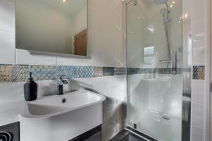 a white bathroom with a sink and a shower at 2 Bed in Skipton oc-ds932 in Skipton +8 photos