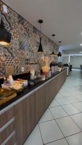 a buffet line in a restaurant with food at Atlanta Hotel in Ibotirama