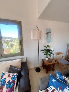 a living room with a couch and a window at Skiathos Seaview Villa with Pool in Punta +35 photos