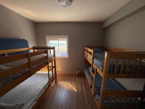 a room with three bunk beds and a window at Piscina Lazer Frente ao Mar in Mongaguá +24 photos