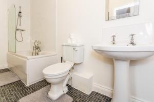 a white bathroom with a toilet and a sink at Two Bed Apartment RYTON With Free Parking in Ryton +27 photos