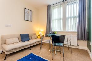 a living room with a couch and a table at Two Bed Apartment RYTON With Free Parking in Ryton