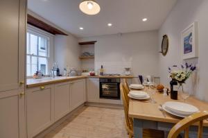 a kitchen with a wooden table and a dining room at 3 Bed in Fowey oc-p00871 in Fowey