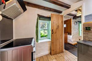 a kitchen with a stove and a window at 3 Bed in Fucheswen oc-c29607 in Blaenau-Ffestiniog