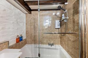 a shower in a bathroom with a bath tub at 3 Bed in Fucheswen oc-c29607 in Blaenau-Ffestiniog +23 photos