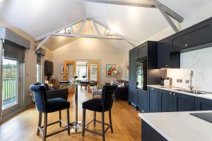 a kitchen with black cabinets and a table and chairs at 1 Bed in Tunstall oc-p30379 in Tunstall