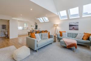 a living room with two couches and a kitchen at 3 Bed in Fearnan oc-s29984 in Chesthill