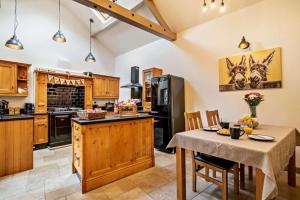 a kitchen with wooden cabinets and a table with chairs at 2 Bed in Bolam oc-b29967 in Ingleton