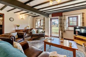 a living room with a couch and a table at 3 Bed in Pentre Bach oc-t30863 in Pentre-bâch